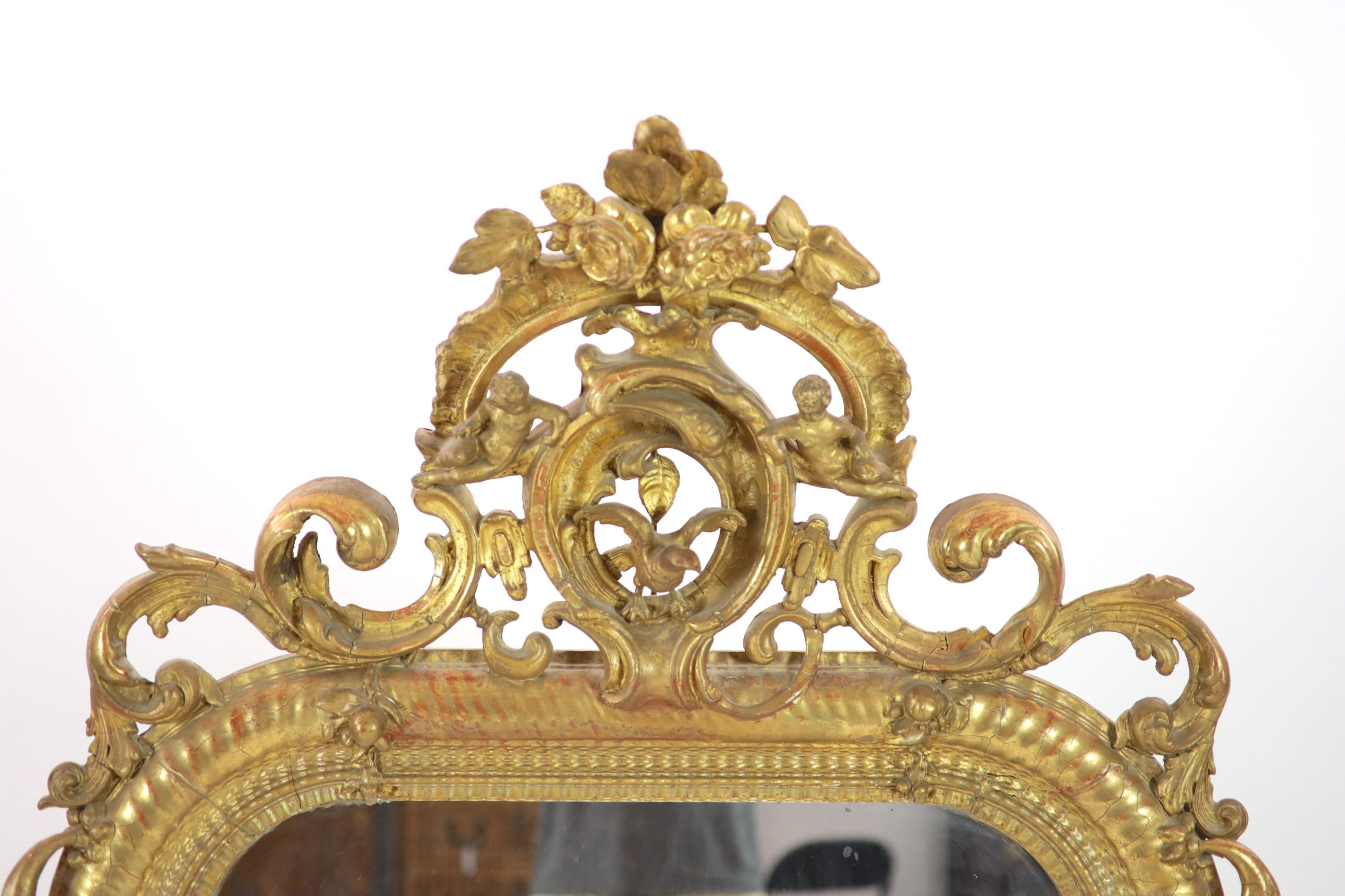 A 19th century French carved giltwood and gesso wall mirror H 175cm. W 97cm.